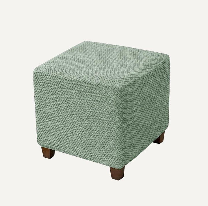 Housse de repose pied carré en jacquard effet tressé Penelope de couleur vert clair sur fond beige